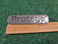 1999-2001 Mazda Protege Emblem Rear Lid Trunk Badge Logo Symbol Chrome OEM 2M4