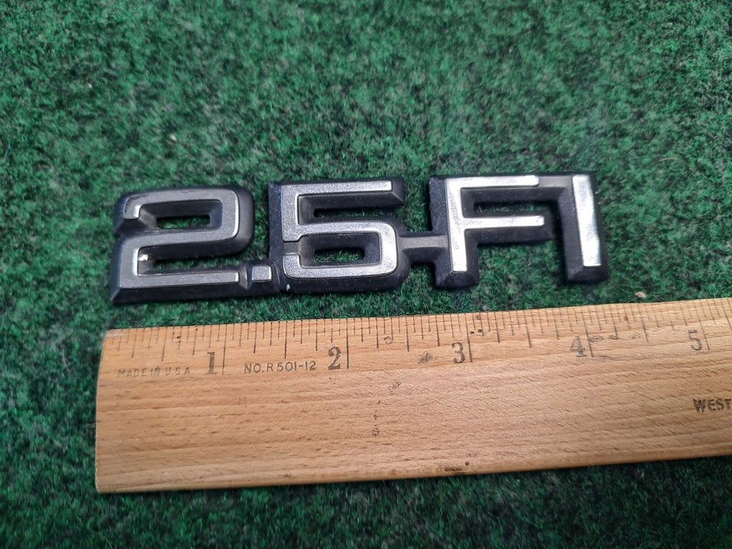 1984-1989 CHEVY CELEBRITY 2.5 FI REAR SIDE EMBLEM BADGE SYMBOL LOGO OEM 4S9