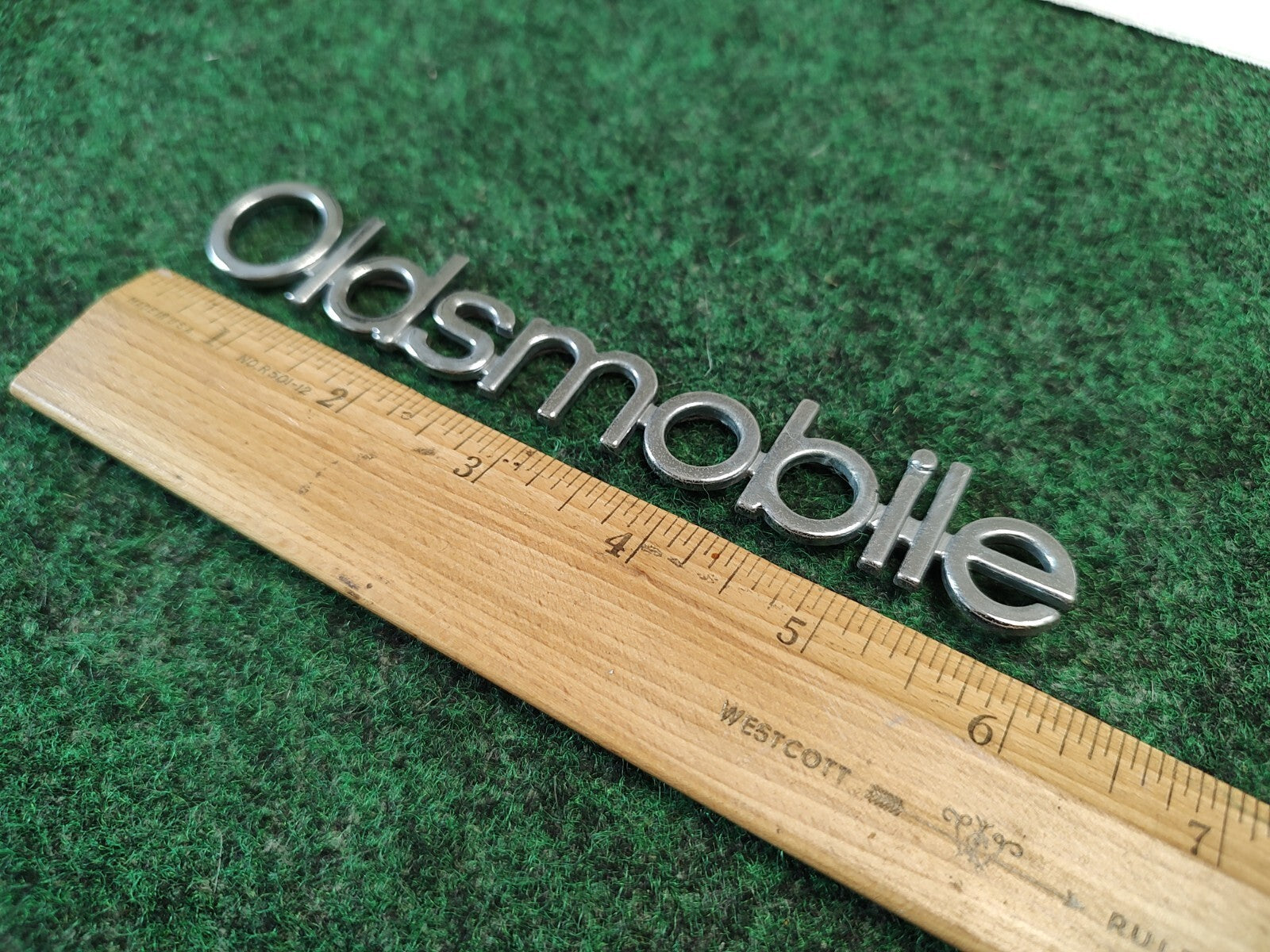 Oldsmobile Cutlass Supreme NOS GM Rear Nameplate Emblem Chrome 16502255 4S7