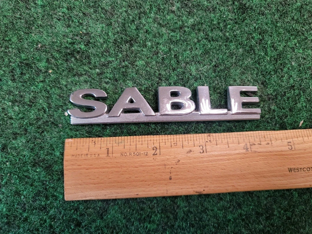 00 01 02 03 MERCURY SABLE REAR GATE LID EMBLEM BADGE SYMBOL LOGO OEM 2M4