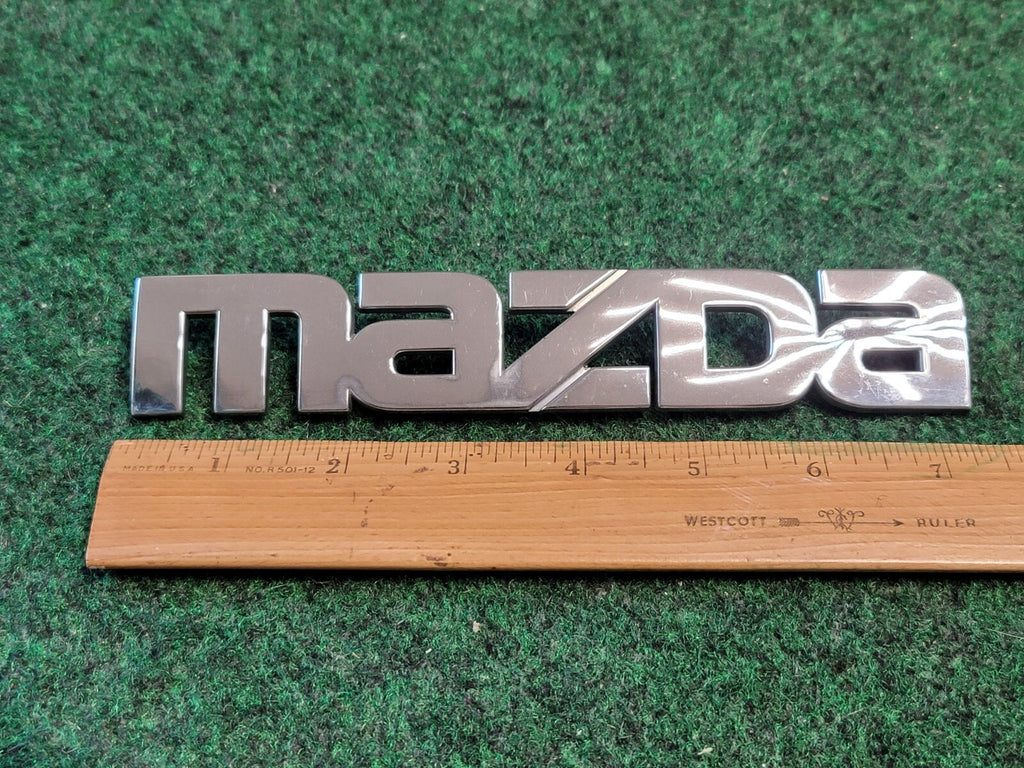 2000-2006 Mazda MPV Rear Emblem Name Plate LC62-51710 7L1