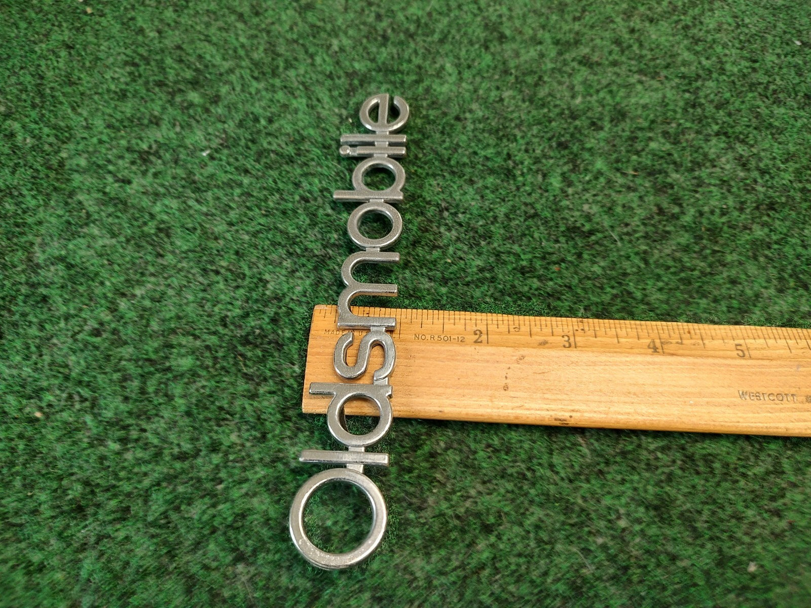 Oldsmobile Cutlass Supreme NOS GM Rear Nameplate Emblem Chrome 16502255 4S7