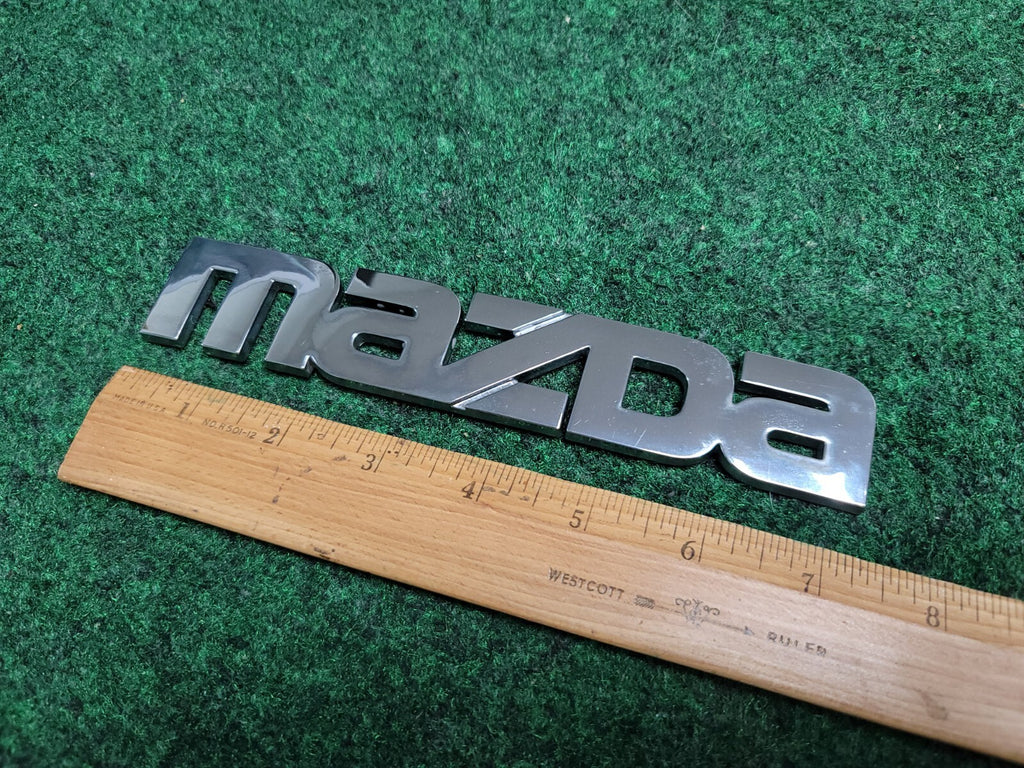 2000-2006 Mazda MPV Rear Emblem Name Plate LC62-51710 2M5