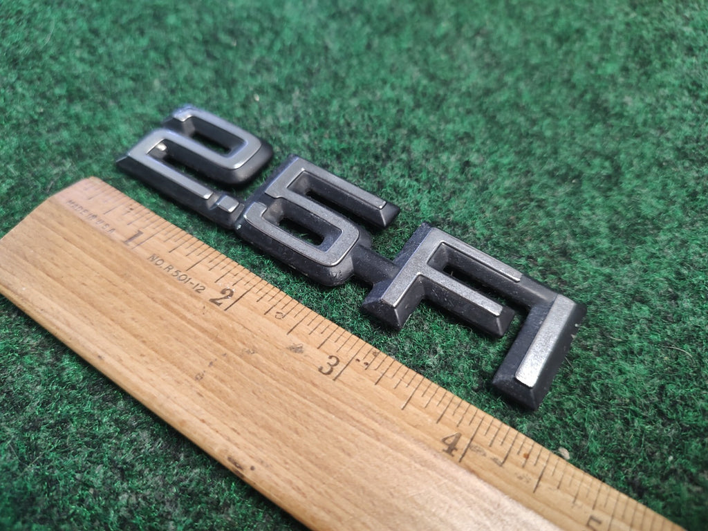 1984-1989 CHEVY CELEBRITY 2.5 FI REAR SIDE EMBLEM BADGE SYMBOL LOGO OEM 4S9