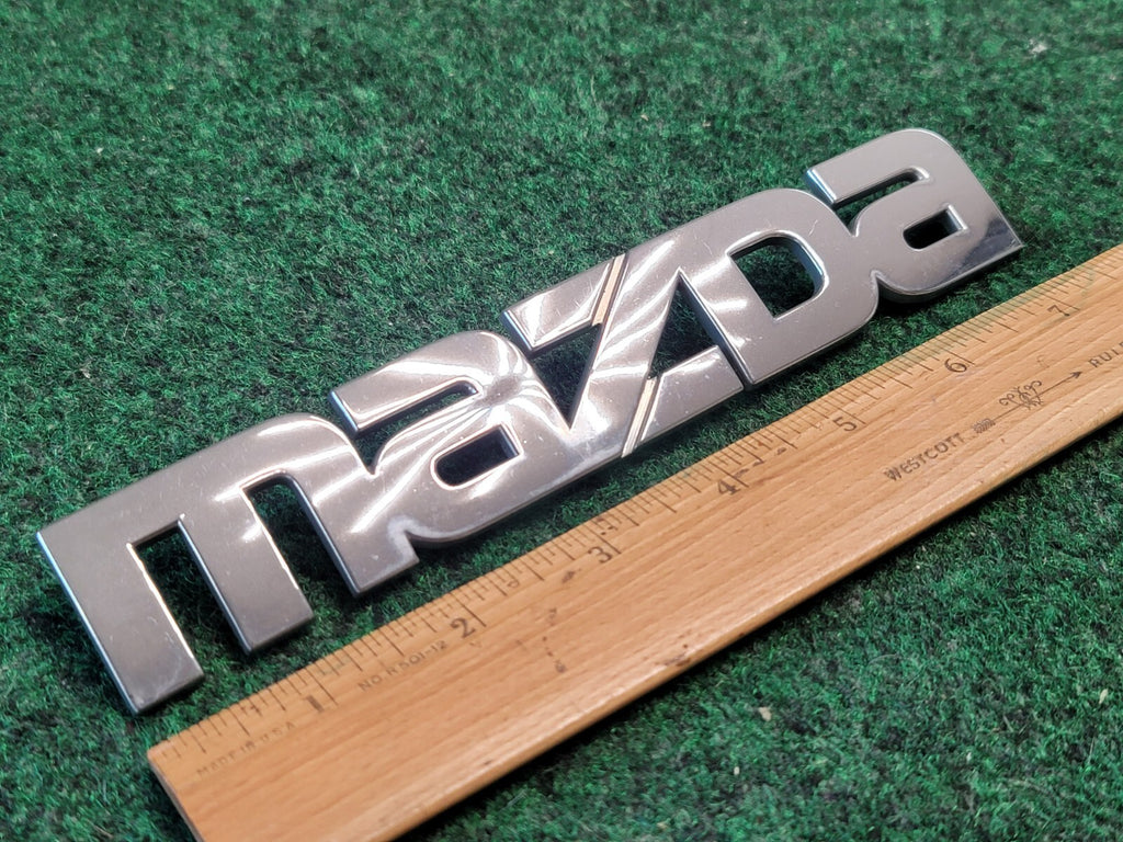 2000-2006 Mazda MPV Rear Emblem Name Plate LC62-51710 7L1